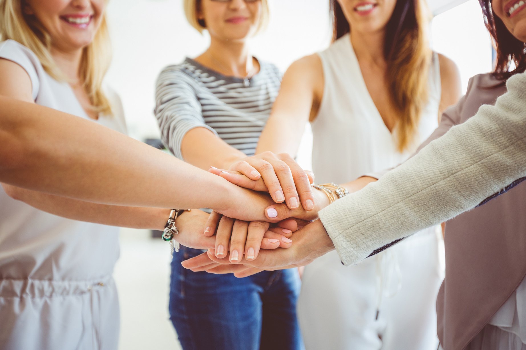 Women’s team. Group of happy women joining hands